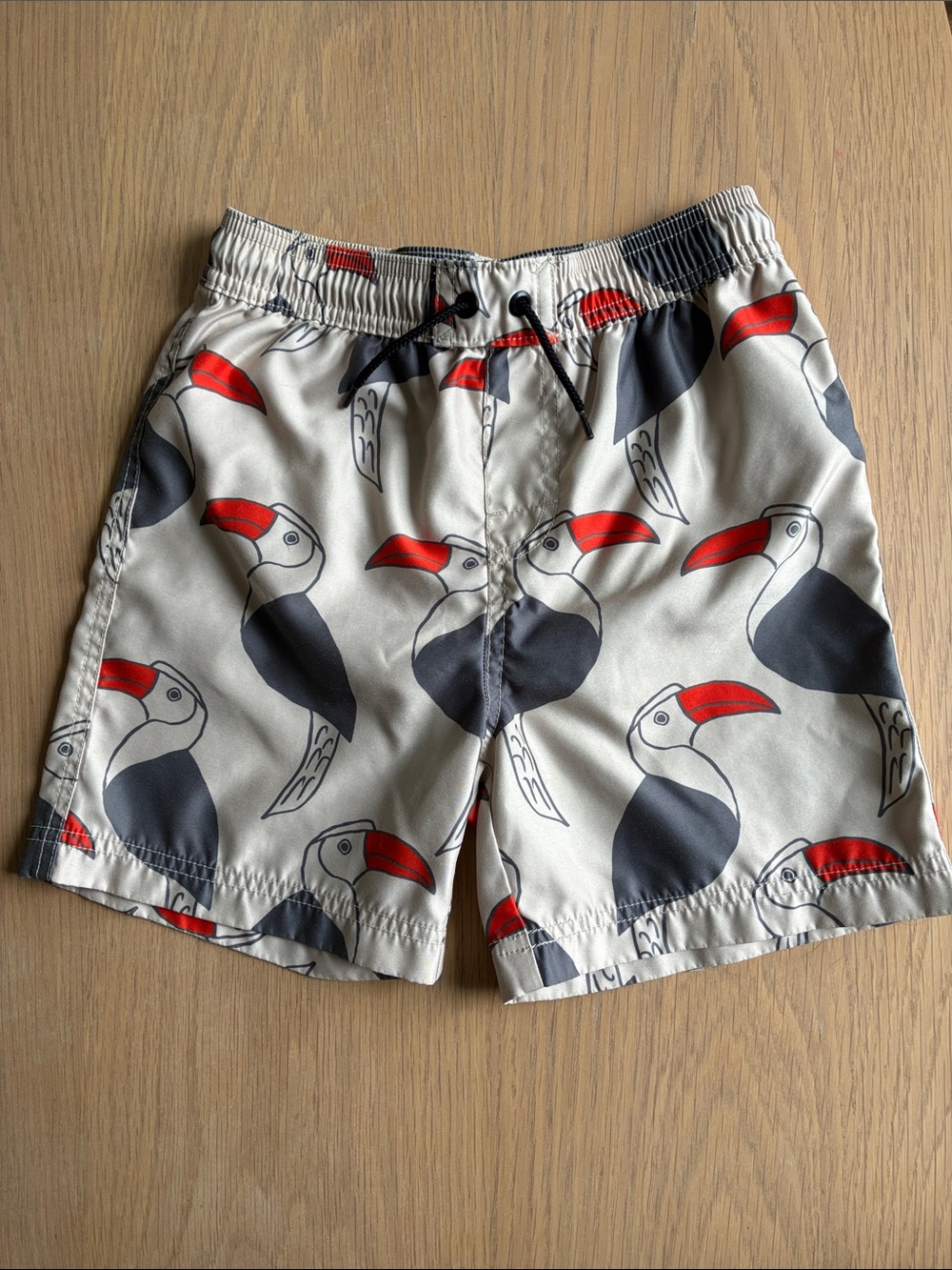 Tea Collection Boys Toucan Print Swim Trunks in White, Red, Navy